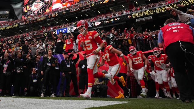 Patrick Mahomes runs out of the tunnel leading his team behind him